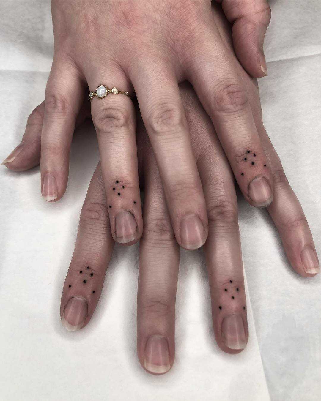 Matching finger tattoos by Tine DeFiore