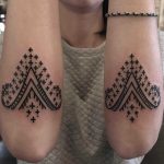 Matching forearm ornaments by Tine DeFiore