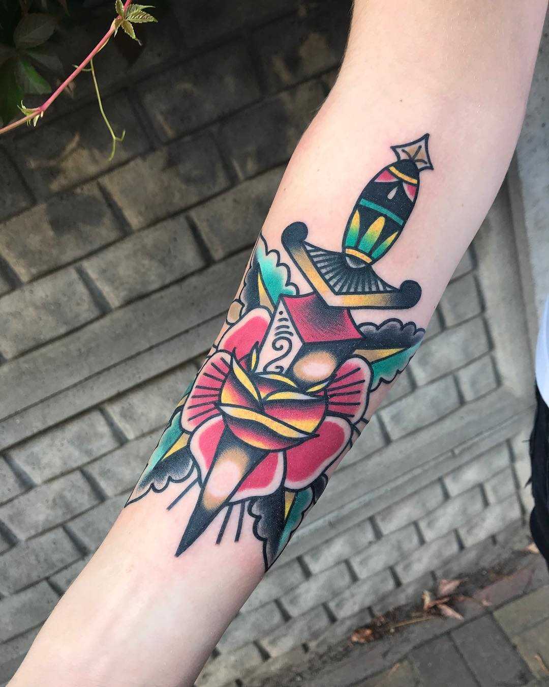 Old-school rose and dagger tattoo by Mike Nofuck