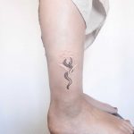 Snake and white lily tattoo by Ann Gilberg