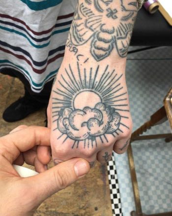 Sun and clouds tattoo by Kirk Budden