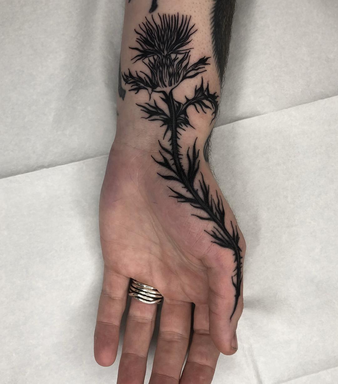 Thistle tattoo by Tine DeFiore 