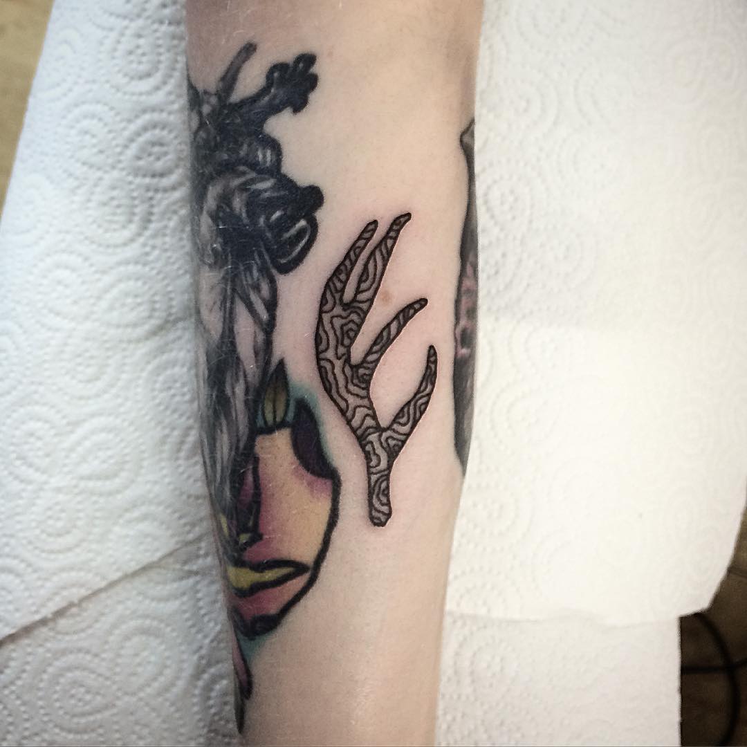Tiny antler tattoo by Deborah Pow