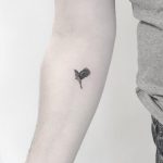 Tiny blackbird tattoo by Annelie Fransson