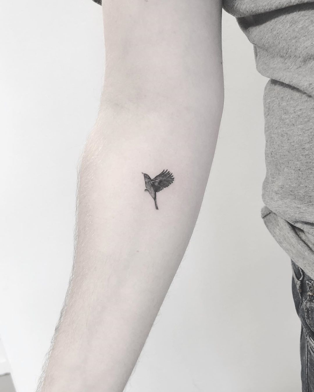 Tiny blackbird tattoo by Annelie Fransson