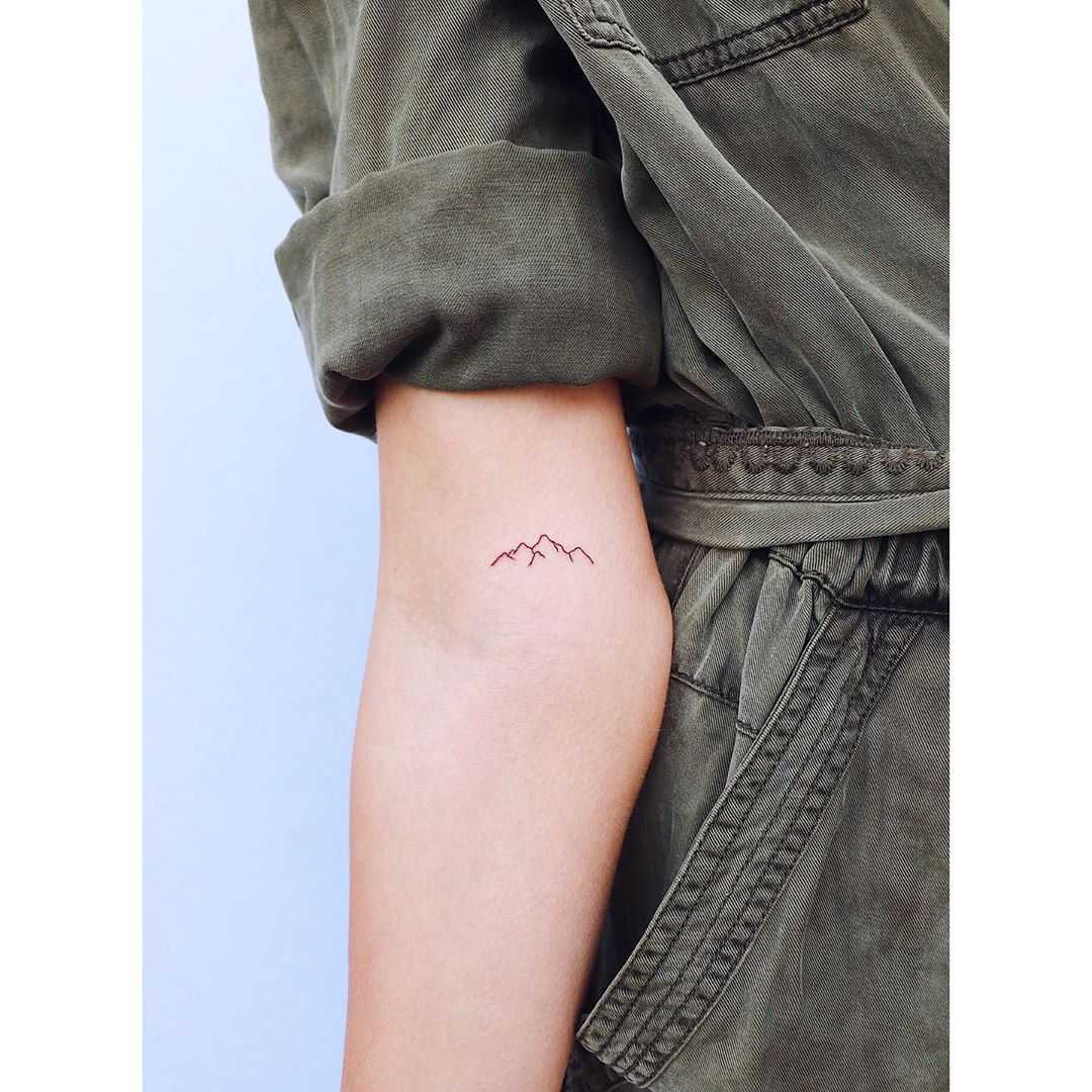 Tiny mountain range tattoo by Zaya Hastra