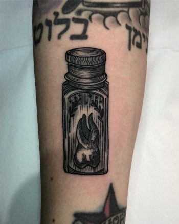 Tooth in a small bottle by Tine DeFiore