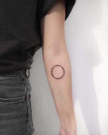 Two circles with some interruptions and dots tattoo by Ann Gilberg