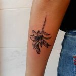 Upside down lily tattoo by Lara Simonetta