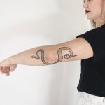 Wrappy elbow snake tattoo by Ann Gilberg