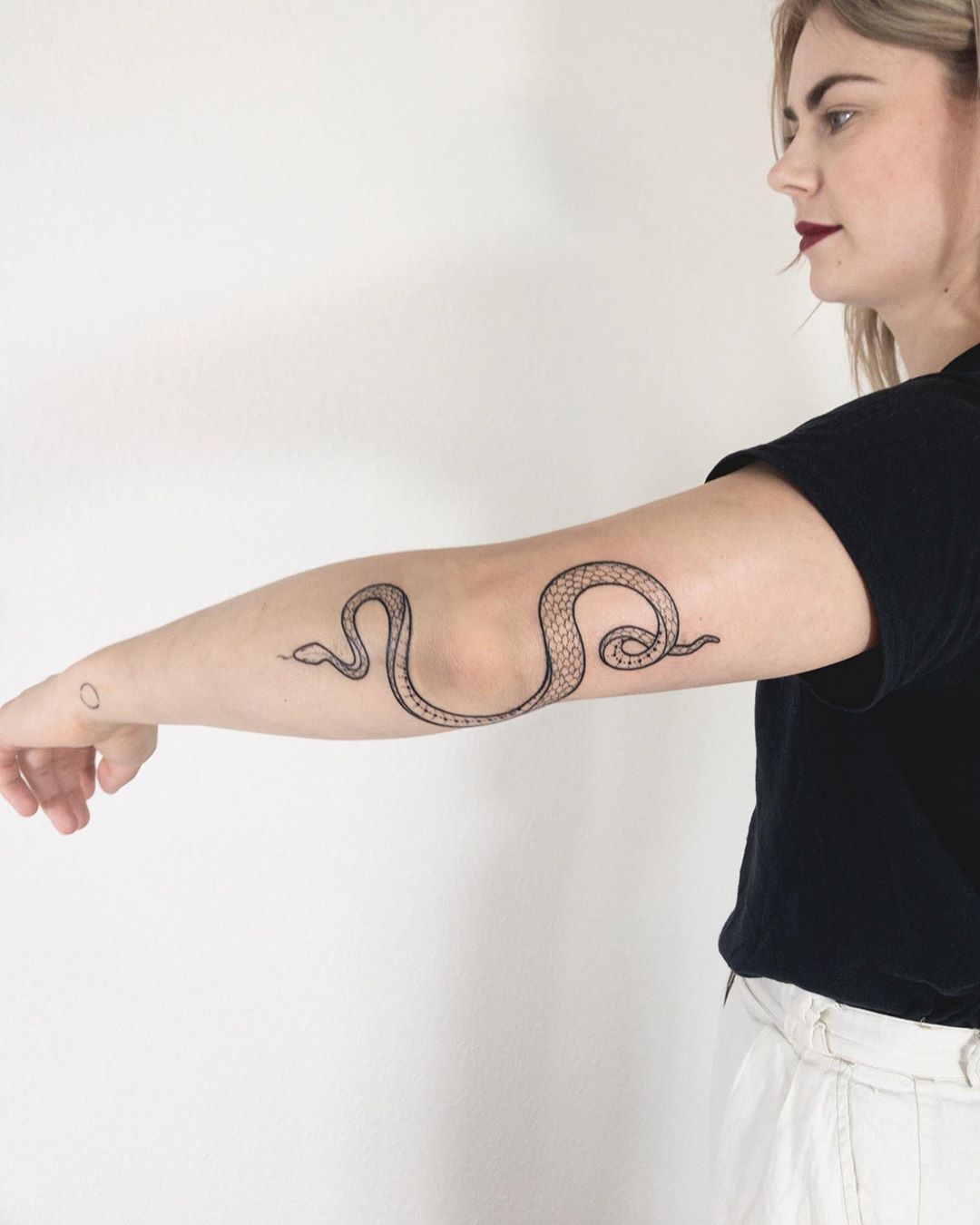 Wrappy elbow snake tattoo by Ann Gilberg