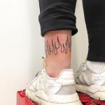 Flames around the left ankle by Hand Job Tattoo