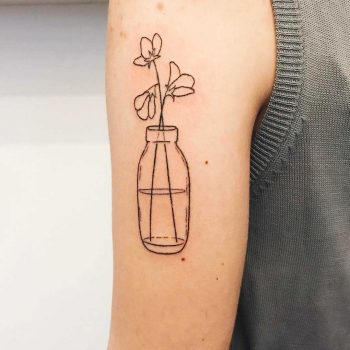 Hand-poked bottle with flowers by Kelli Kikcio