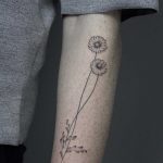 Hand-poked daisy tattoo by Lara Maju
