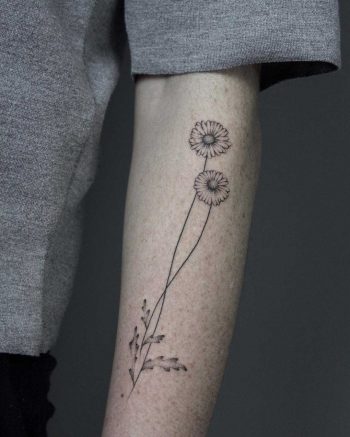 Hand-poked daisy tattoo by Lara Maju