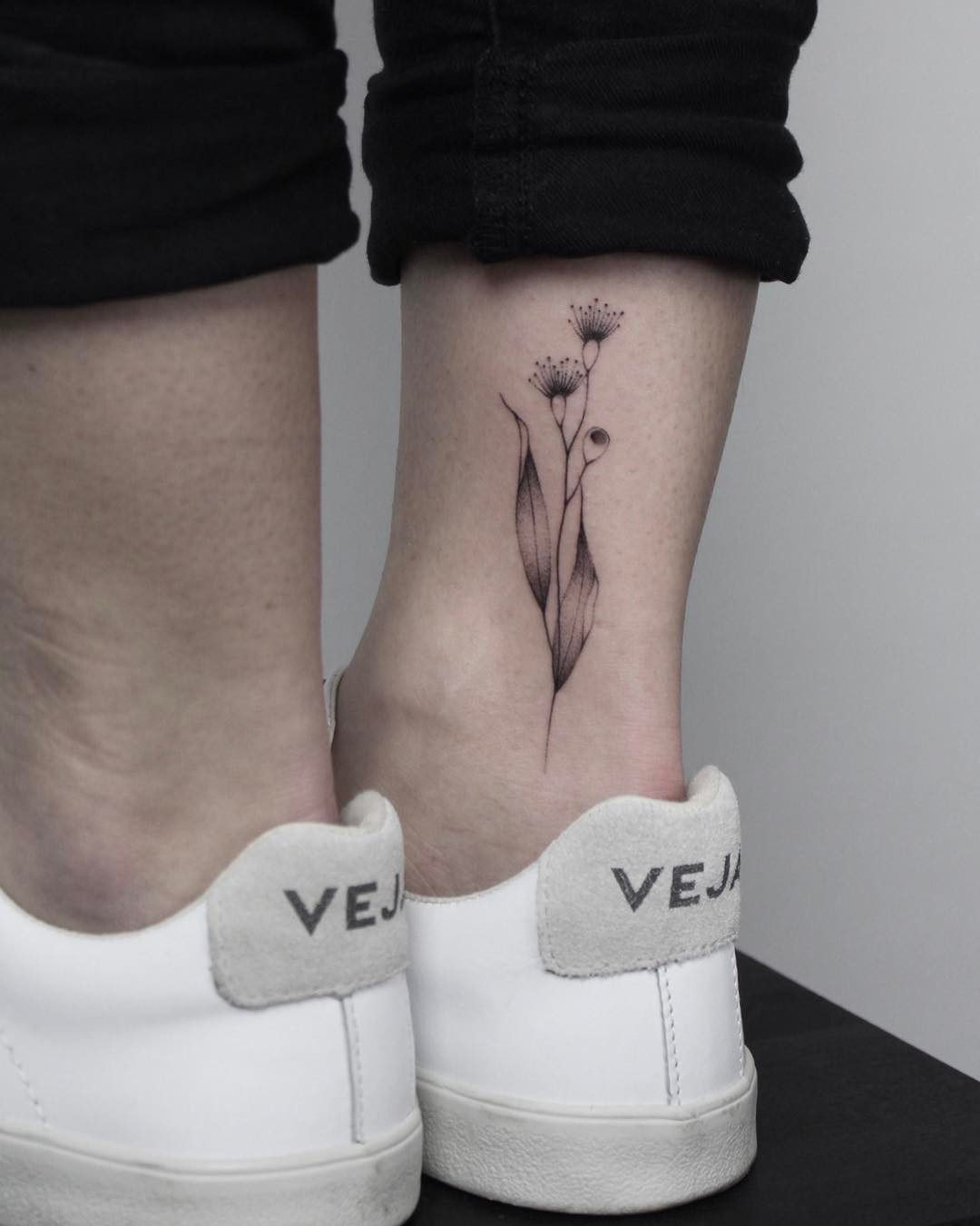 Hand-poked eucalyptus tattoo by Lara Maju