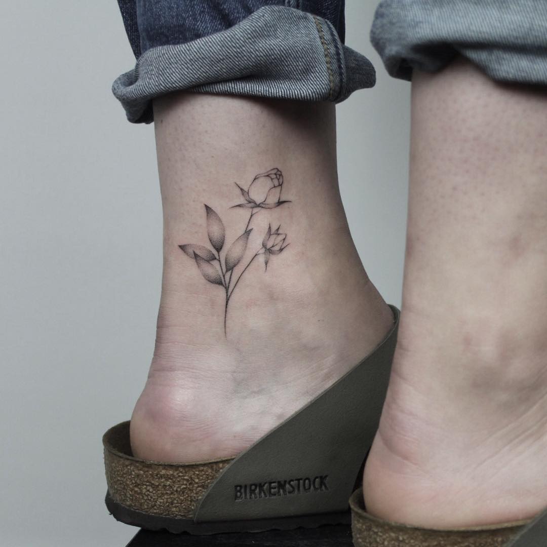 Hand-poked rose on an ankle by Lara Maju