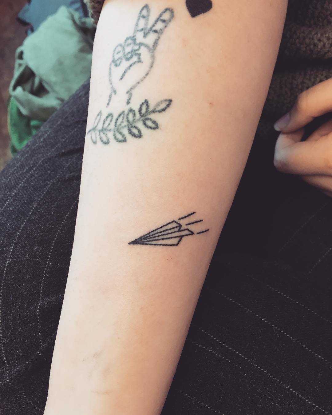 Little paper plane tattoo by Kirk Budden