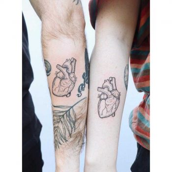 Matching heart tattoos by Zaya Hastra
