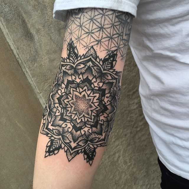 Ornamental mandala on a forearm by Tine DeFiore