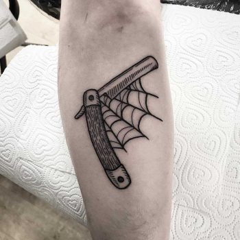 Razor blade and spider web by Deborah Pow
