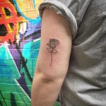 Single line rose tattoo by Kirk Budden