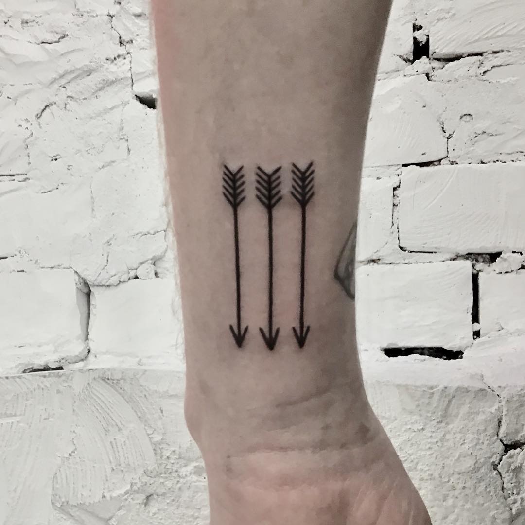 Three tiny arrows tattoo by Kevin Jenkins