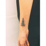 Tiny Christmas tree tattoo by Zaya Hastra