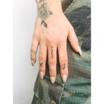 Tiny finger tattoos by Zaya Hastra