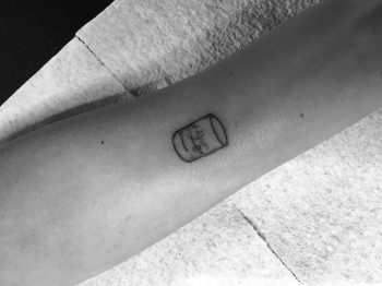 Tiny scotch glass tattoo by Robbie Ra Moore