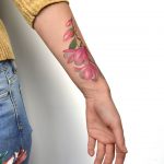 Watercolor flowers on the left forearm by Mavka Leesova
