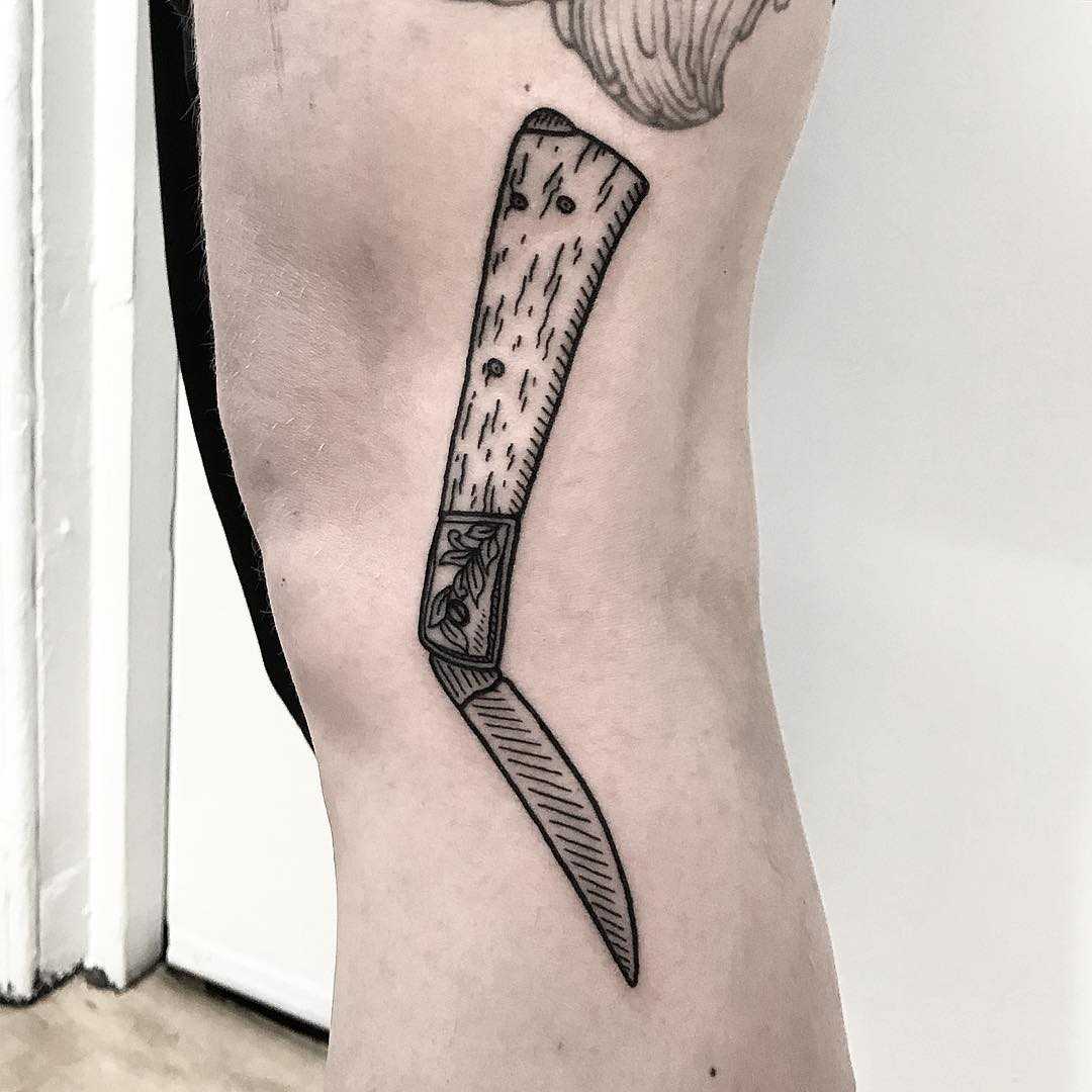 Woodcut style knife tattoo by Deborah Pow