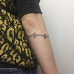 Wrapping barbed wire tattoo by Jessica Rubbish