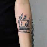 A burning laptop by Hand Job Tattoo