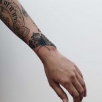 Black butterfly on the left wrist by Finley Jordan