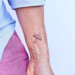 Cute little umbrella tattoo by Zaya Hastra