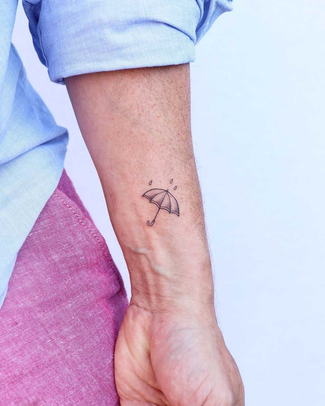 Cute little umbrella tattoo by Zaya Hastra