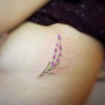 Delicate watercolor flower by tattooist G.NO