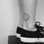 Hand-poked leave on an ankle by Lara Maju