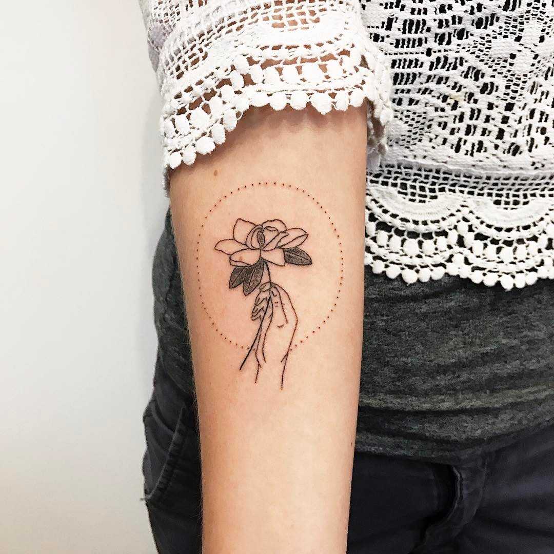 Hand-poked magnolia tattoo by Kelli Kikcio