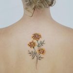 Marigold tattoo on the back by tattooist picsola
