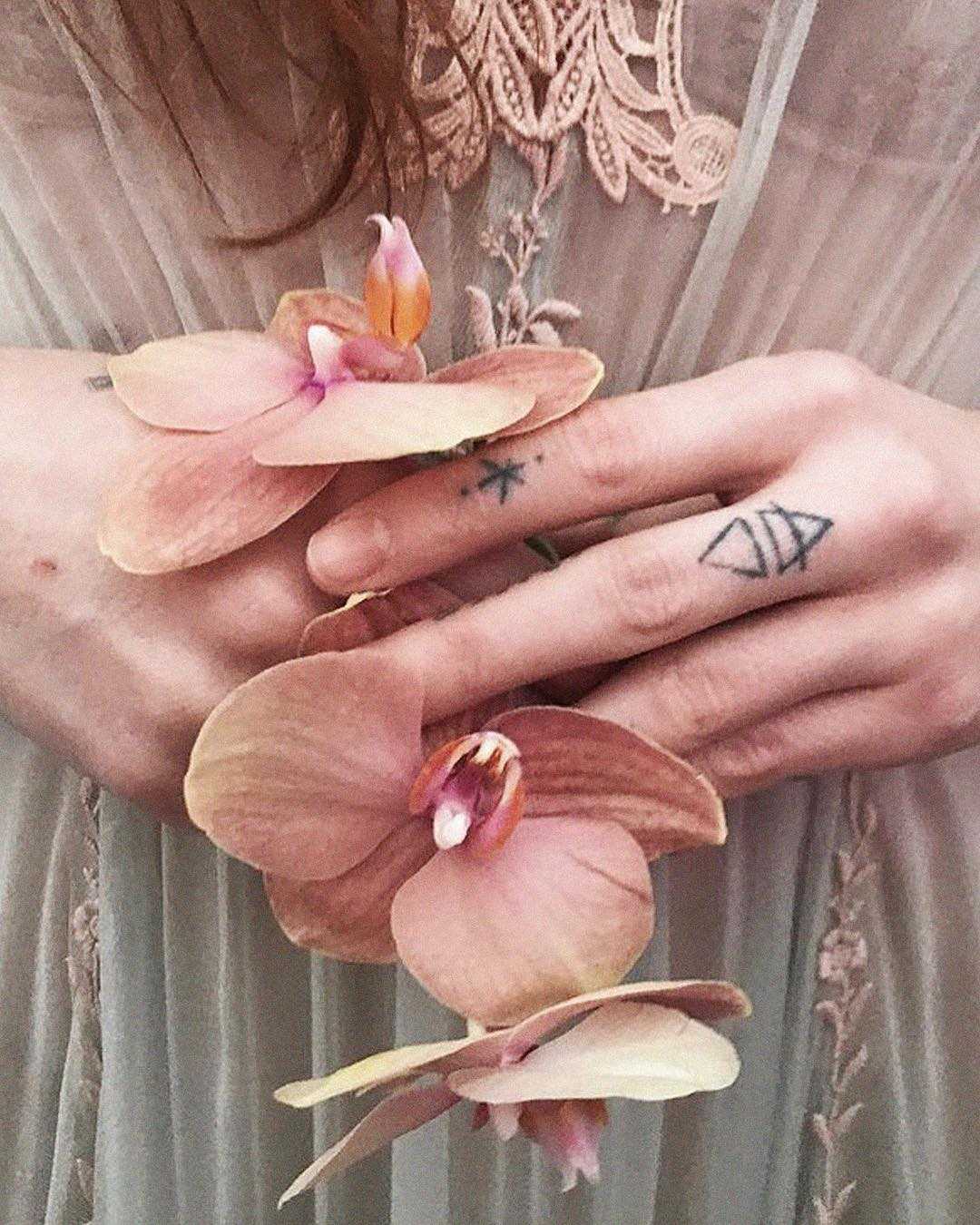 Small tattoos on fingers by Stanislava Pinchuk