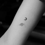 Tiny Saturn and moon tattoos by Jakub Nowicz