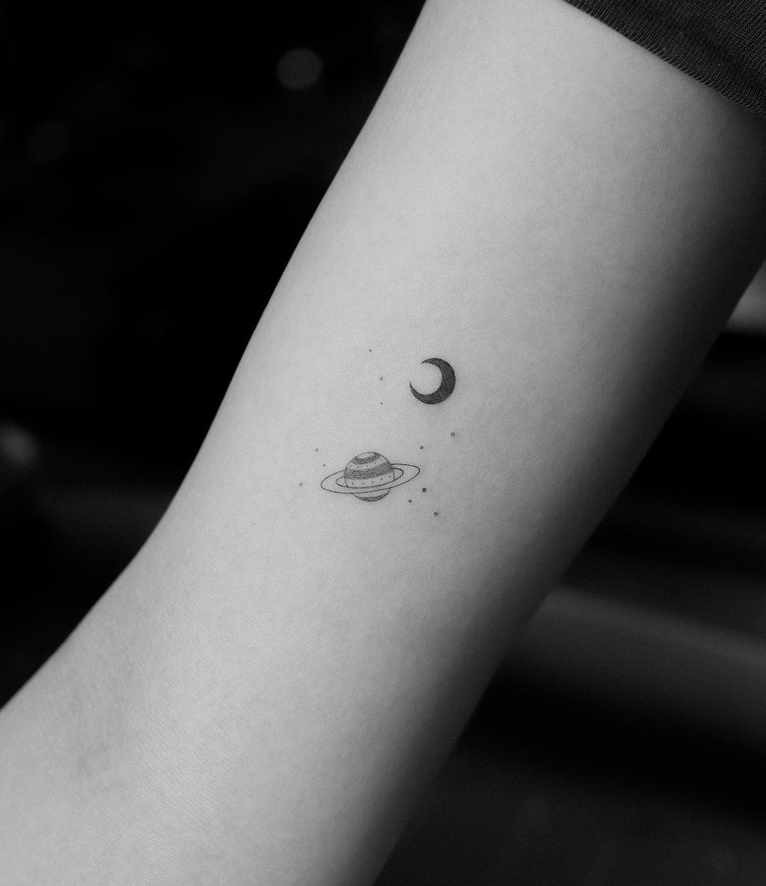 Tiny Saturn and moon tattoos by Jakub Nowicz