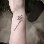 Tiny daffodil tattoo by Kirk Budden