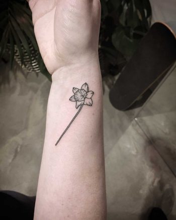 Tiny daffodil tattoo by Kirk Budden
