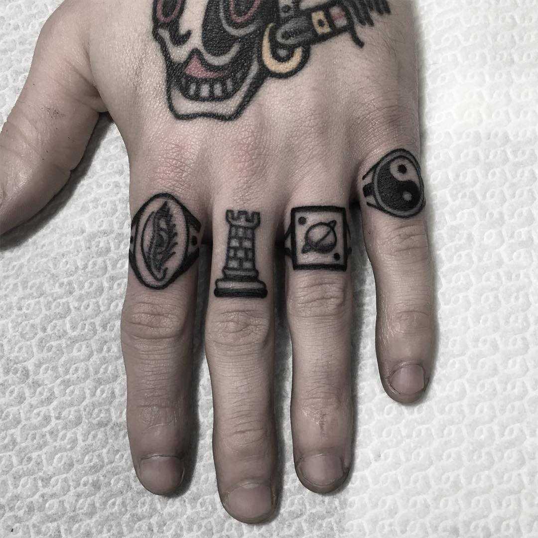 Tiny finger tattoos by Carina Soares