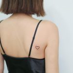 Tiny heart on the back by tattooist Nemo