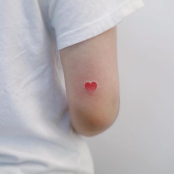 Tiny heart tattoo by tattooist Nemo