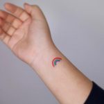 Tiny rainbow tattoo by tattooist Nemo